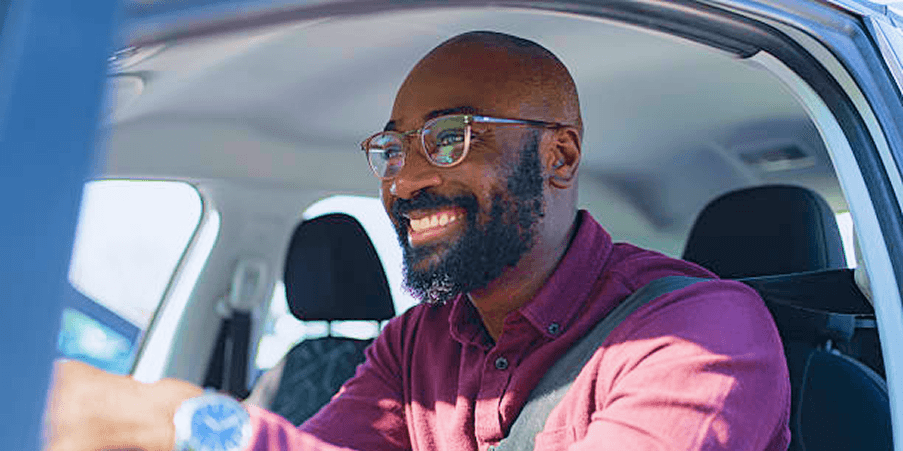 Confident Nigerian man ready to drive, urban background